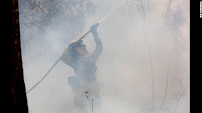 California slide northern wildfire man fire thousands arrested rages threatening homes Cell phone combusts severely burns california man